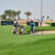 People playing golf on a green grass and Caffeine lab logo is Showen as a sponsor