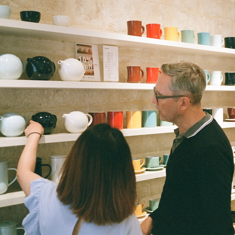 Loveramics designers reviewing colorful mugs, pots and cups shelves