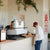 A coffee bar in a golf event with a barista making cappuccino to a customer